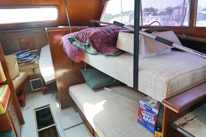 Slide: The Image of Interior of a 1962 Chris-Craft Roamer 36 boat with bunk beds and storage items. - 10