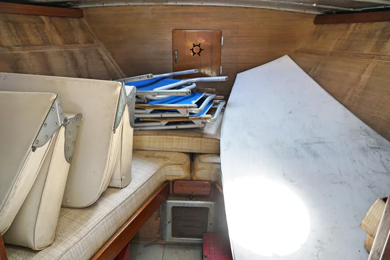 Slide: The Image of Interior cabin of 1962 Chris-Craft Roamer 36 with folded chairs and table. - 11
