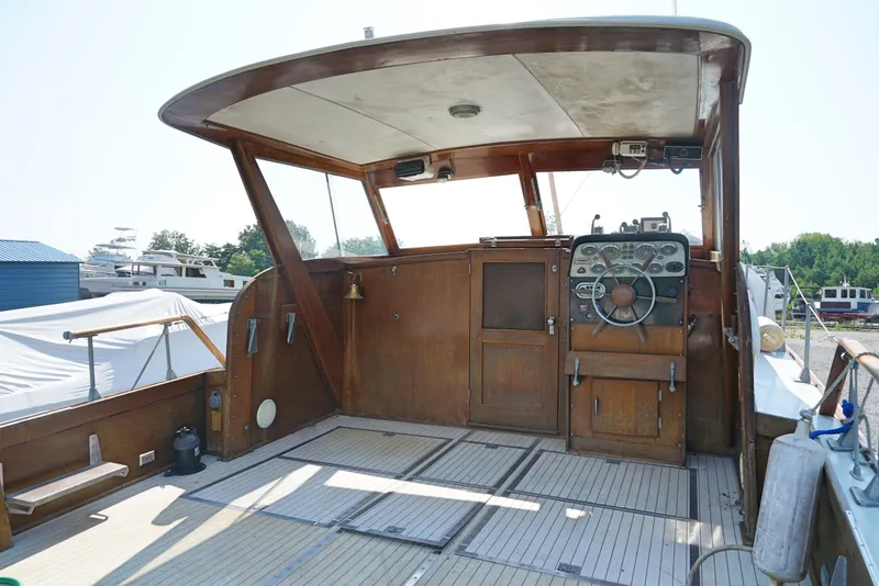 Slide: The Image of 1962 Chris-Craft Roamer 36 boat cockpit with wooden interior and steering wheel. - 3