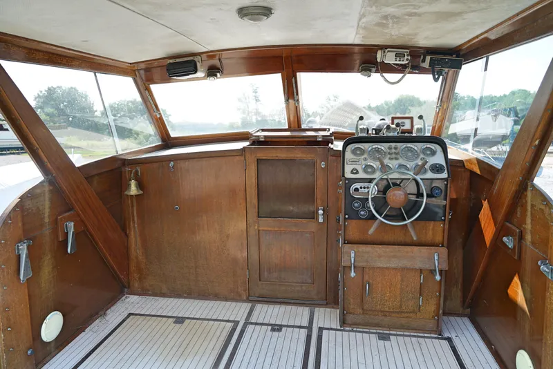 Slide: The Image of 1962 Chris-Craft Roamer 36 boat helm with wooden dashboard and vintage steering wheel. - 4
