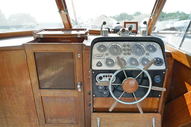 Slide: The Image of 1962 Chris-Craft Roamer 36 boat helm with vintage wooden dashboard and steering wheel. - 5