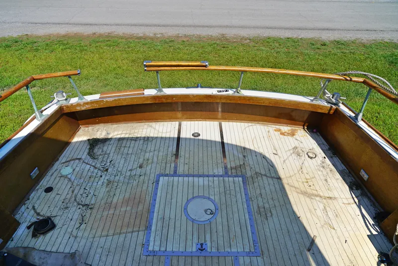 Slide: The Image of 1962 Chris-Craft Roamer 36 boat deck with wooden railings and weathered flooring. - 6
