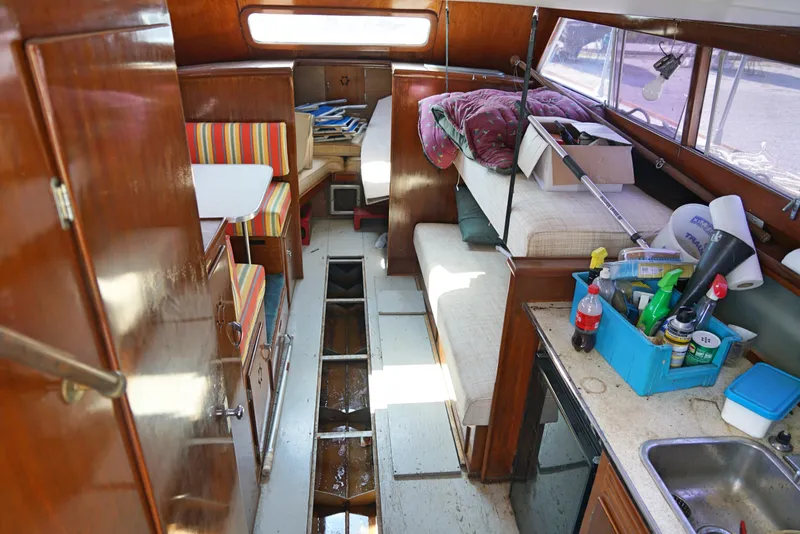 Slide: The Image of Interior of a 1962 Chris-Craft Roamer 36 boat with visible seating and kitchen area. - 7