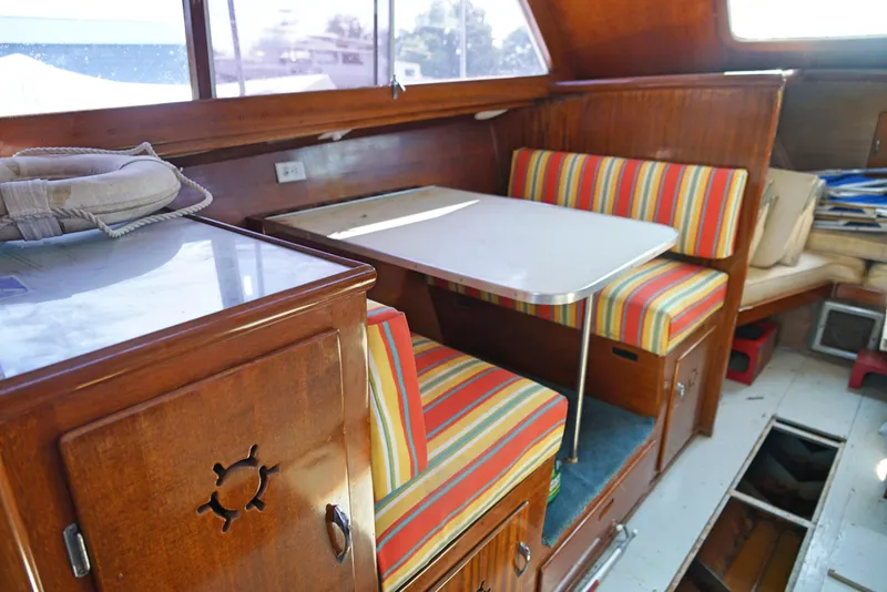 Slide: The Image of 1962 Chris-Craft Roamer 36 interior with colorful striped seating and wooden cabinetry. - 9