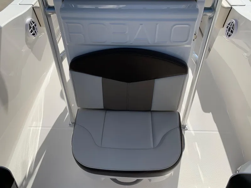 Slide: The Image of 2024 Robalo R202 Explorer boat seat with logo, white and black upholstery. - 18