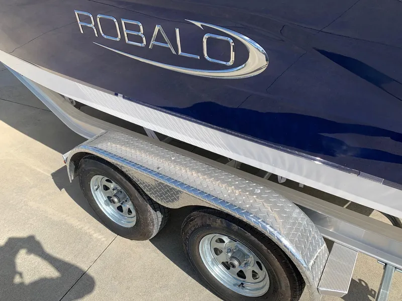 Slide: The Image of 2024 Robalo R202 Explorer boat on a dual-axle trailer. - 5
