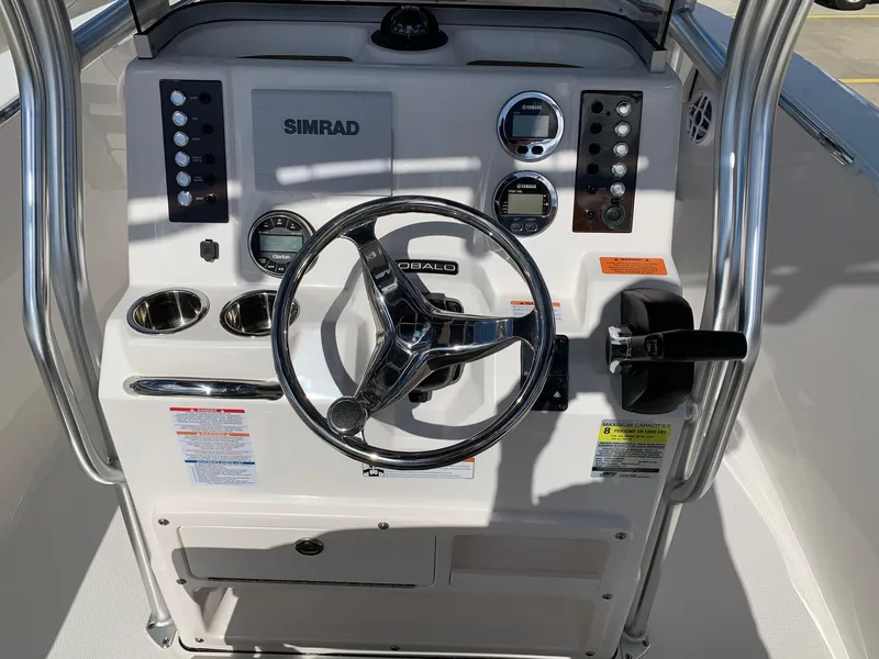 Slide: The Image of 2024 Robalo R202 Explorer boat dashboard with steering wheel and control panel. - 10