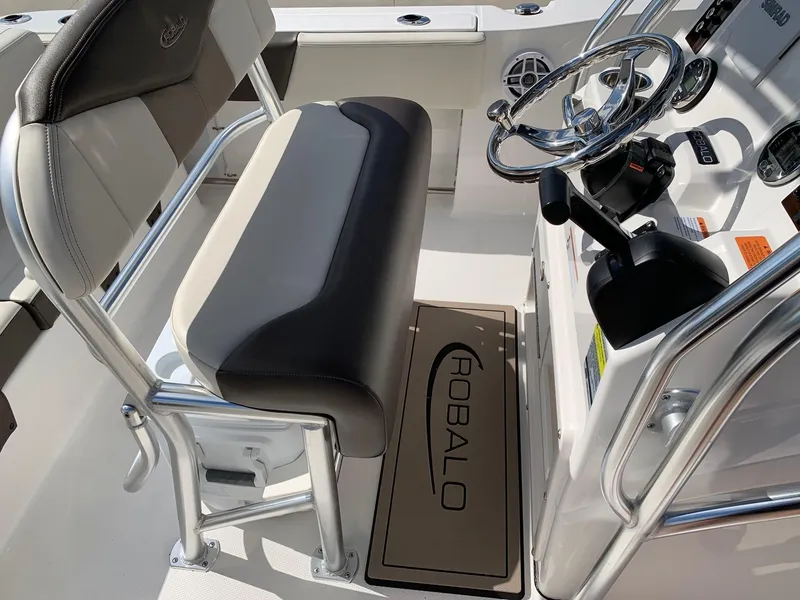 Slide: The Image of 2024 Robalo R202 Explorer boat interior with steering console and seating. - 11