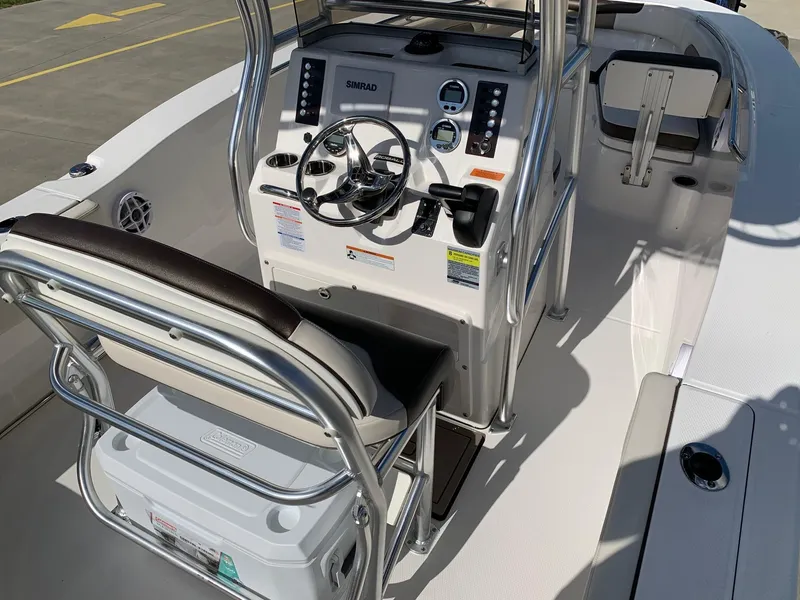 Slide: The Image of 2024 Robalo R202 Explorer boat console with steering wheel and seating. - 12