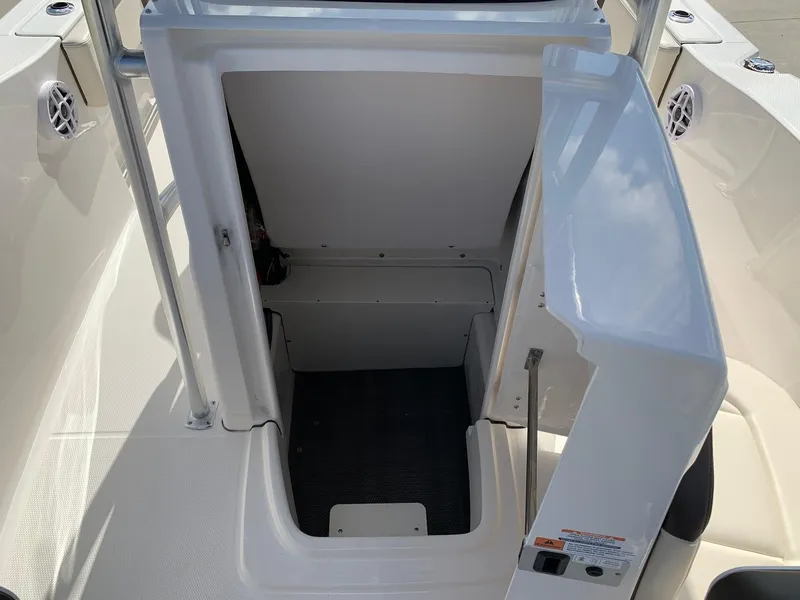 Slide: The Image of 2024 Robalo R202 Explorer boat storage compartment with open door. - 17