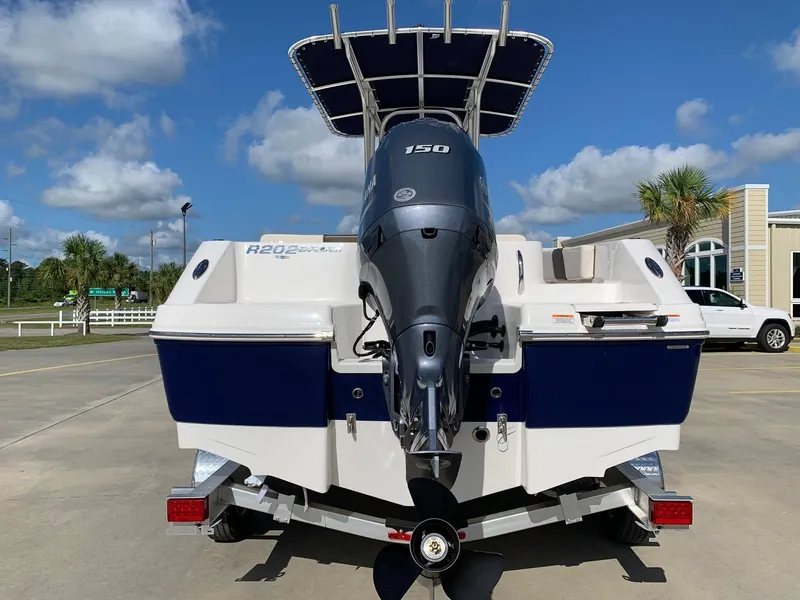 Slide: The Image of 2024 Robalo R202 Explorer boat with 150 HP engine, rear view on trailer. - 2