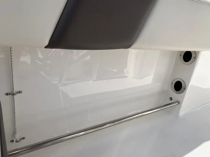 Slide: The Image of 2024 Robalo R202 Explorer interior detail with stainless steel rail and white finish. - 23