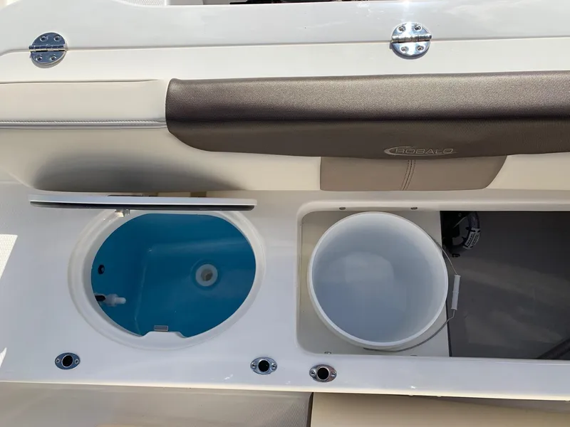 Slide: The Image of 2024 Robalo R202 Explorer boat livewell and storage compartment. - 24