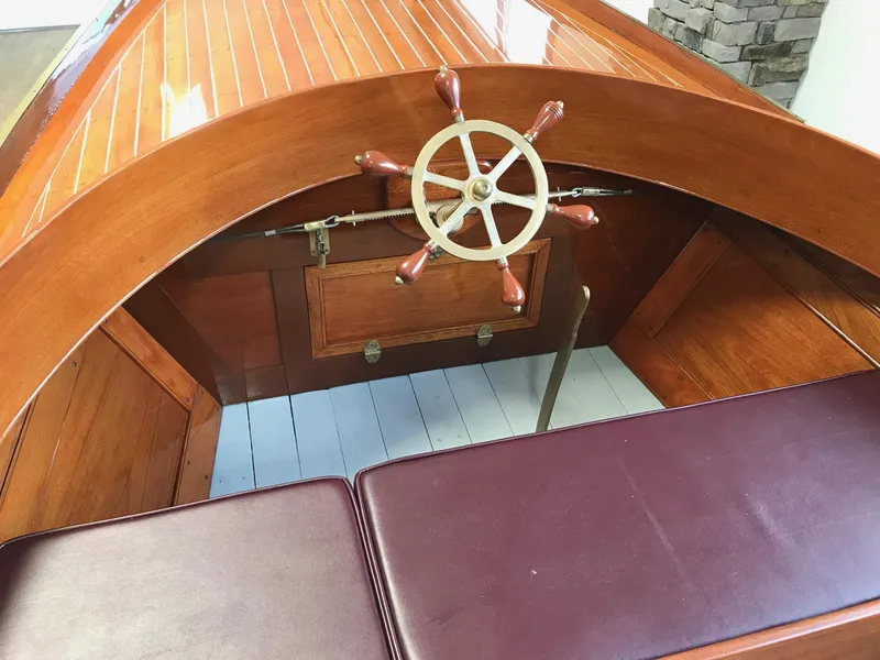 Slide: The Image of Vintage 1905 New York Launch 20 boat interior with wooden steering wheel and leather seats. - 3