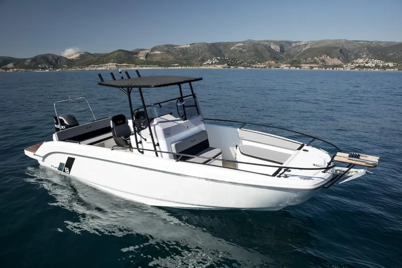 Slide: The Image of 2024 Beneteau Flyer 8 SPACEdeck boat cruising on open water with scenic mountain backdrop. - 3