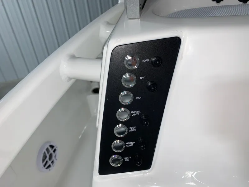 Slide: The Image of Control panel of 2024 Robalo 226 Cayman boat with various switches and buttons. - 15