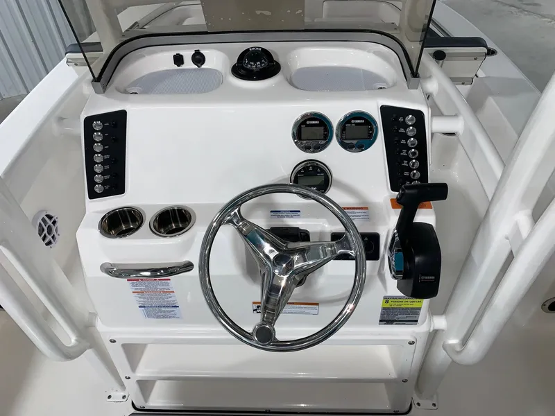 Slide: The Image of 2024 Robalo 226 Cayman boat console with steering wheel and control panel. - 18