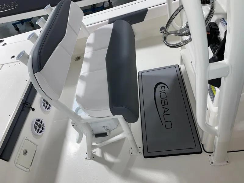 Slide: The Image of 2024 Robalo 226 Cayman boat interior with seating and Robalo branded mat. - 19
