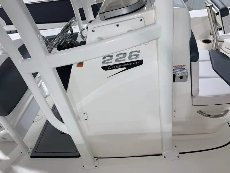 Slide: The Image of 2024 Robalo 226 Cayman boat console with steering wheel and seating. - 20
