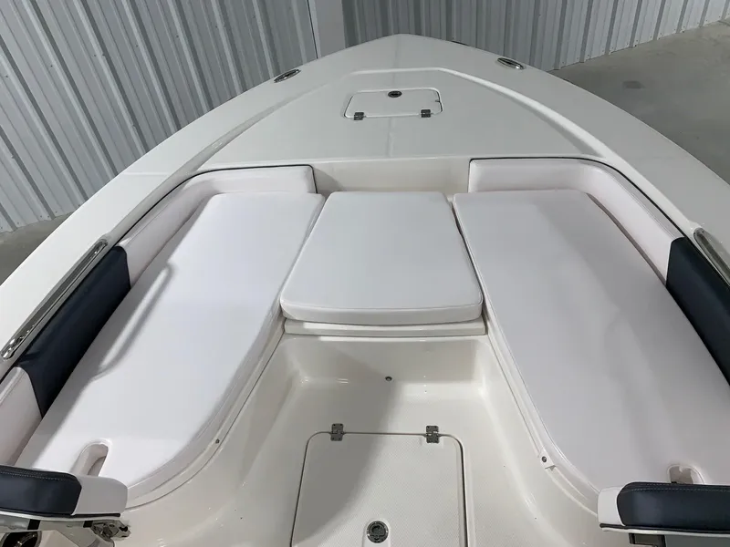 Slide: The Image of 2024 Robalo 226 Cayman boat bow seating area with white cushions. - 21