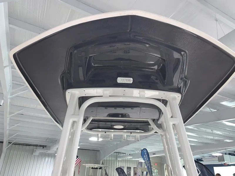 Slide: The Image of 2024 Robalo 226 Cayman boat underside view in showroom. - 24