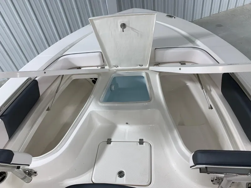 Slide: The Image of 2024 Robalo 226 Cayman boat interior storage compartments and seating. - 27