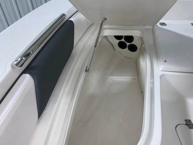 Slide: The Image of 2024 Robalo 226 Cayman boat storage compartment with open hatch. - 29