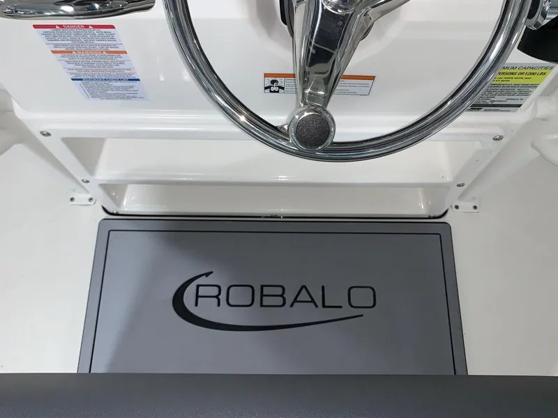 Slide: The Image of 2024 Robalo 226 Cayman boat steering wheel and branded mat. - 12