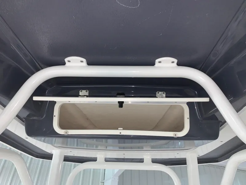 Slide: The Image of 2024 Robalo 226 Cayman boat storage compartment under T-top. - 14