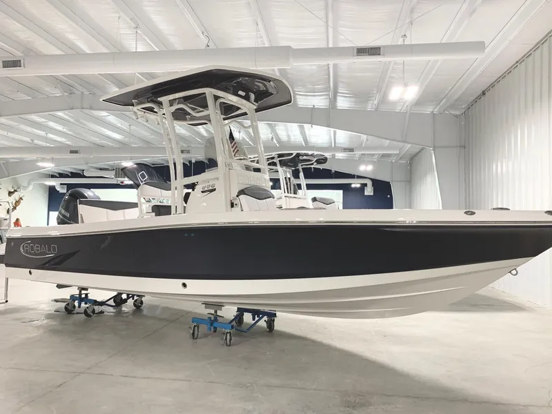 Slide: The Image of 2024 Robalo 226 Cayman boat in showroom. - 2