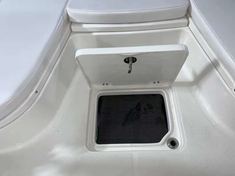 Slide: The Image of 2024 Robalo 226 Cayman boat storage compartment with open hatch. - 22