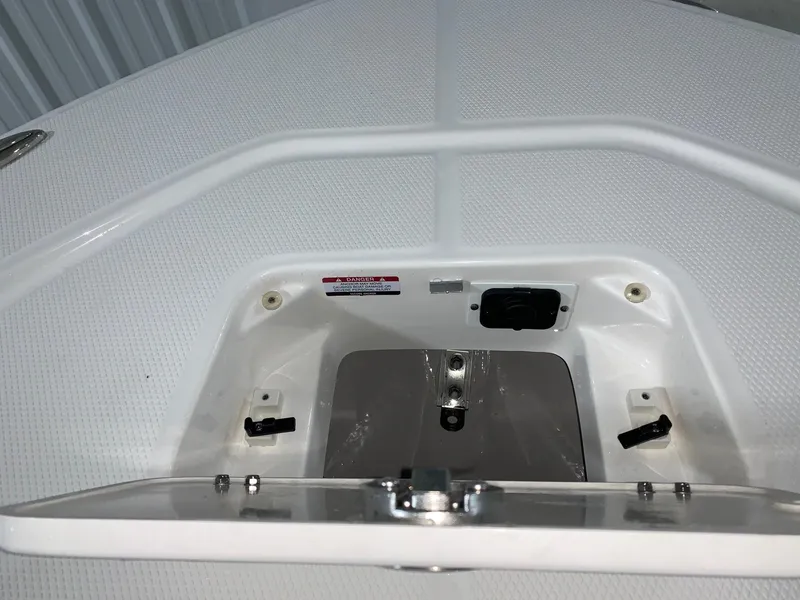 Slide: The Image of 2024 Robalo 226 Cayman boat storage compartment with open hatch. - 25