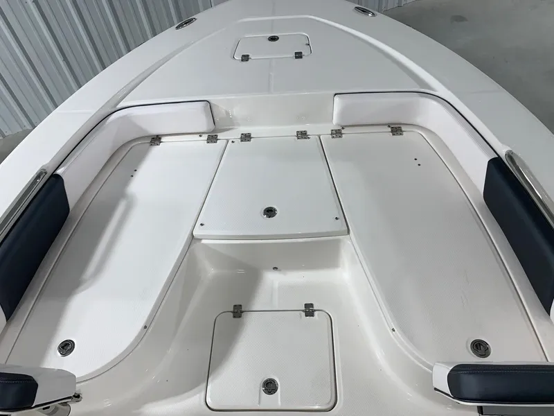 Slide: The Image of 2024 Robalo 226 Cayman boat deck with storage compartments and seating. - 29