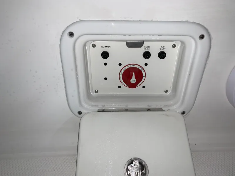 Slide: The Image of 2024 Robalo 226 Cayman boat control panel with red switch and white casing. - 30