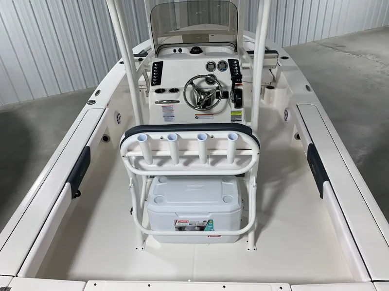 Slide: The Image of 2024 Robalo 226 Cayman boat interior with steering console and rod holders. - 5