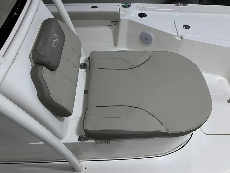 Slide: The Image of 2024 Key West 250 Bay Reef boat seating area with cushioned seats. - 11