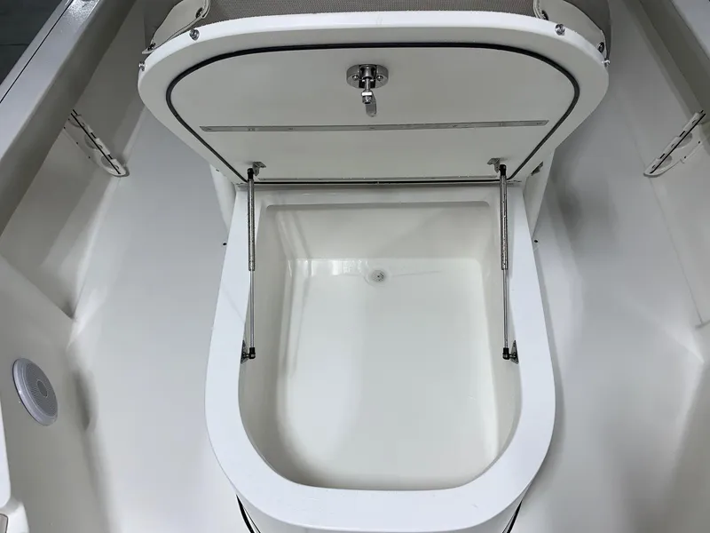 Slide: The Image of 2024 Key West 250 Bay Reef boat storage compartment with open lid. - 12