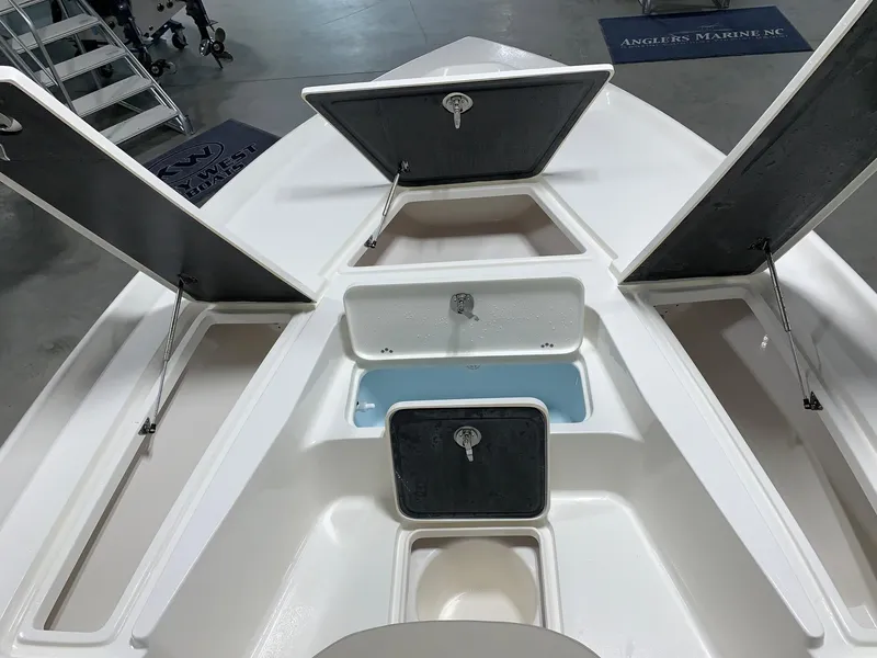 Slide: The Image of 2024 Key West 250 Bay Reef boat with open storage compartments. - 14