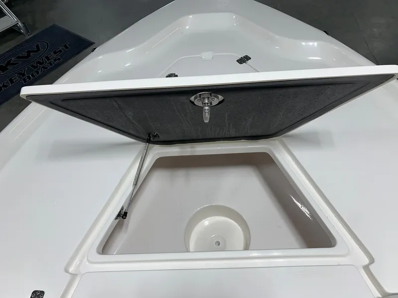 Slide: The Image of 2024 Key West 250 Bay Reef storage compartment with open hatch. - 15