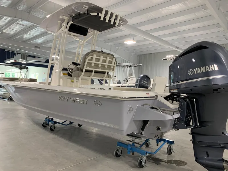 Slide: The Image of 2024 Key West 250 Bay Reef boat with Yamaha outboard motor in showroom. - 2