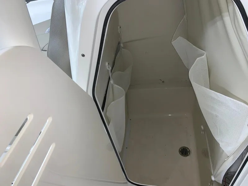 Slide: The Image of 2024 Key West 250 Bay Reef interior storage compartment with mesh pockets. - 21