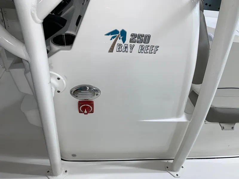 Slide: The Image of 2024 Key West 250 Bay Reef boat console with logo and ignition switch. - 22