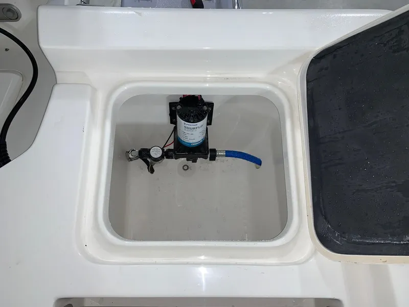 Slide: The Image of 2024 Key West 250 Bay Reef boat compartment with pump system. - 25