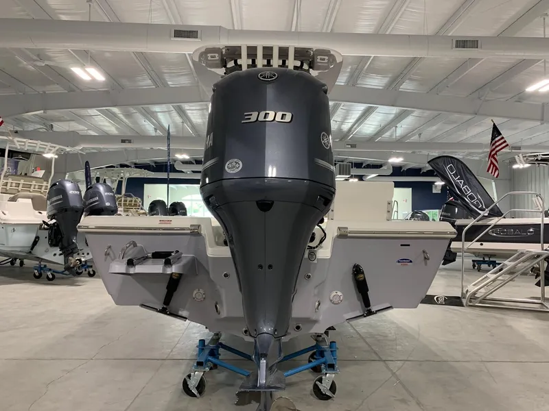 Slide: The Image of 2024 Key West 250 Bay Reef boat with a 300 HP engine in a showroom. - 4