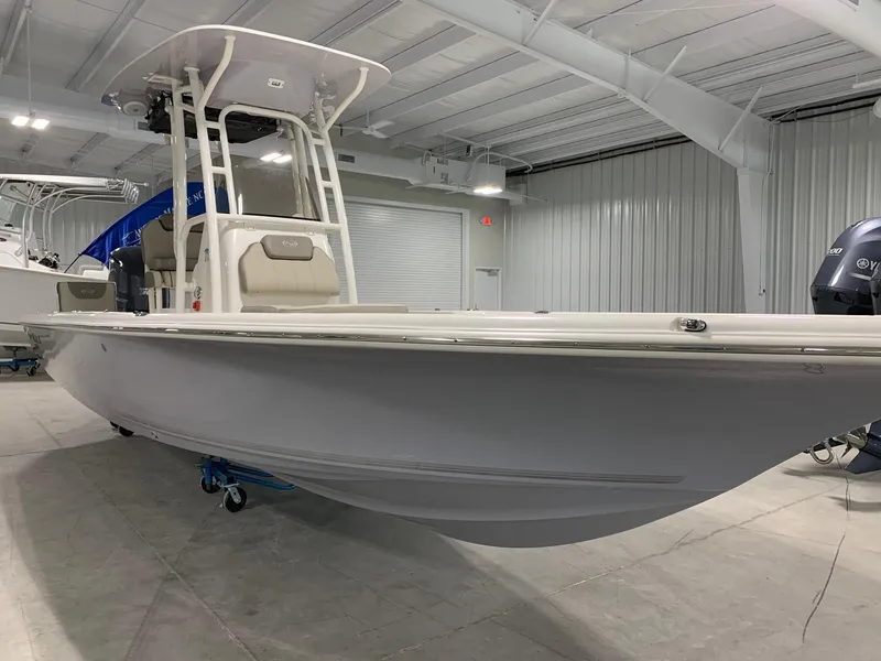 Slide: The Image of 2024 Key West 250 Bay Reef boat in a showroom. - 1