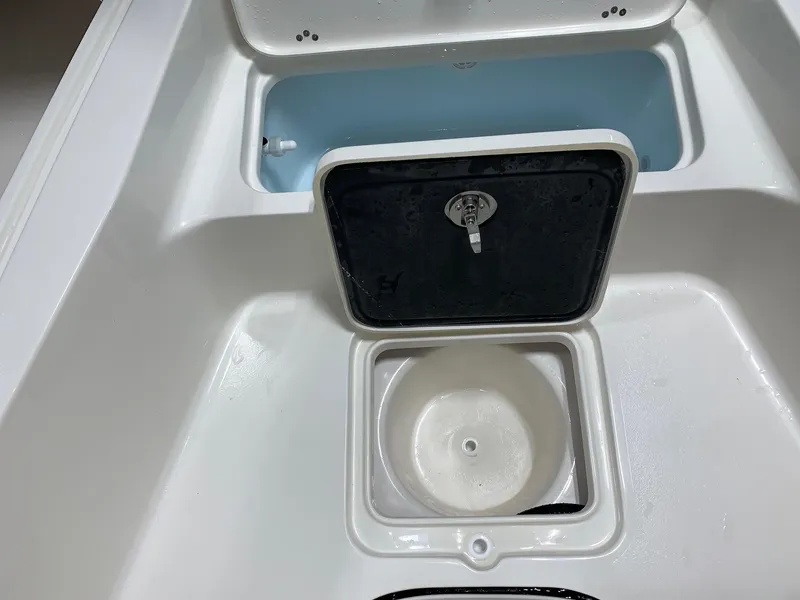 Slide: The Image of 2024 Key West 250 Bay Reef boat storage compartments and livewell. - 16