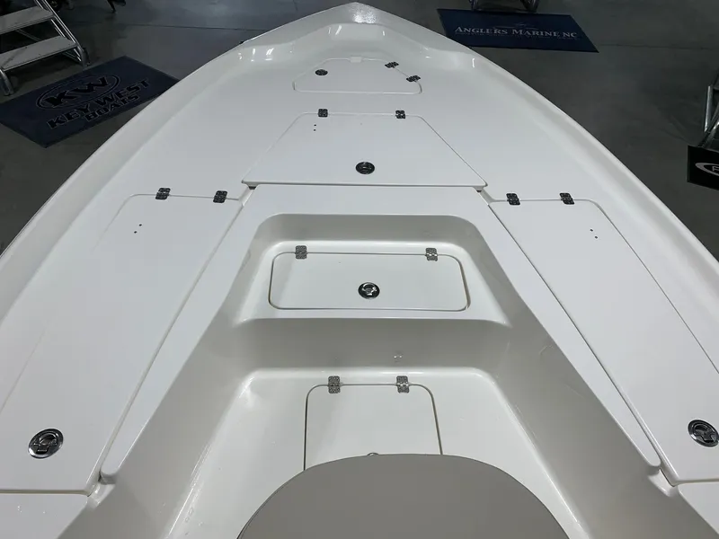 Slide: The Image of 2024 Key West 250 Bay Reef boat deck with storage compartments. - 19