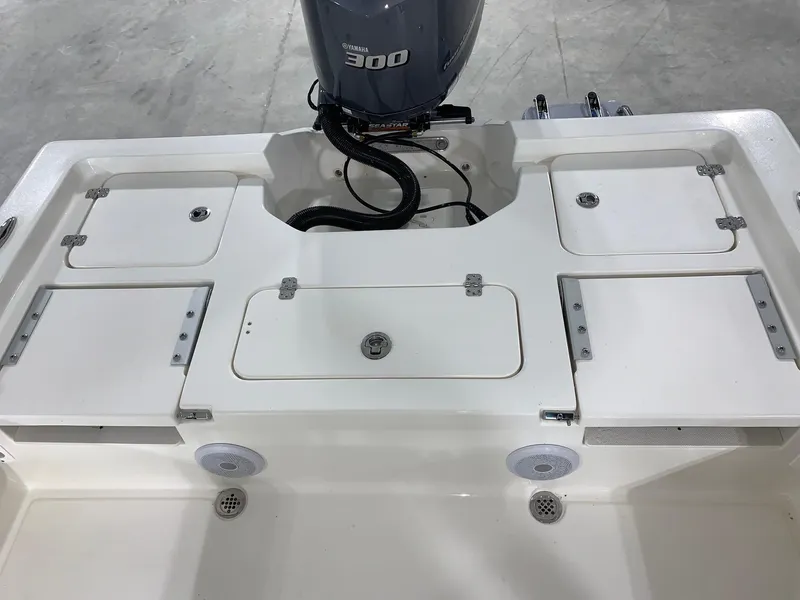 Slide: The Image of 2024 Key West 250 Bay Reef boat stern with storage compartments and Yamaha 300 engine. - 28