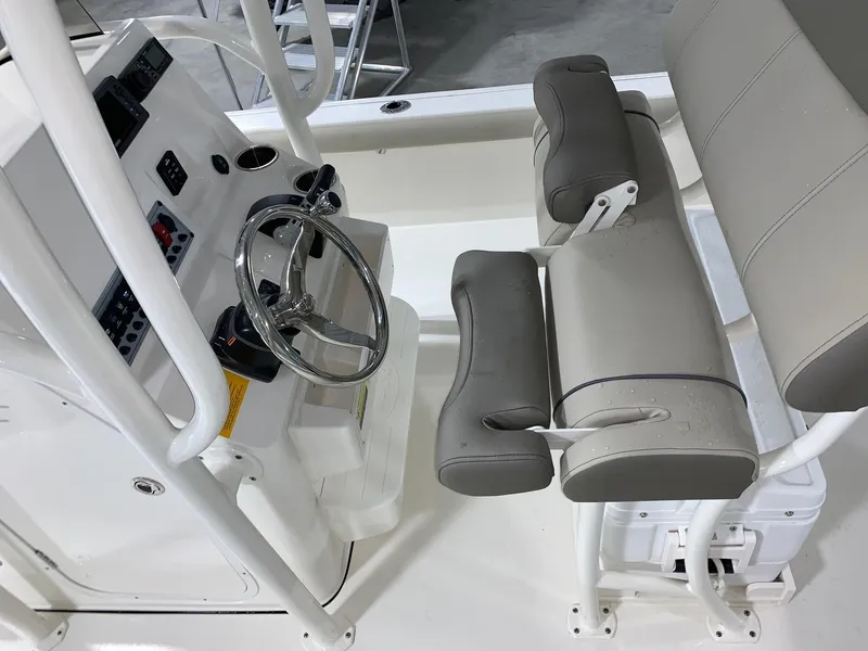 Slide: The Image of 2024 Key West 250 Bay Reef boat interior with steering wheel and seating. - 31