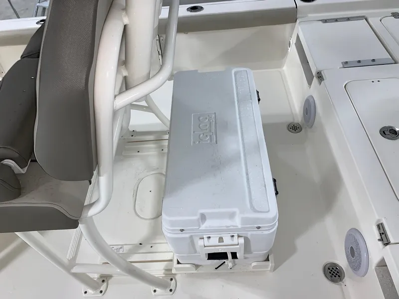 Slide: The Image of 2024 Key West 250 Bay Reef boat interior with cooler and seating. - 32